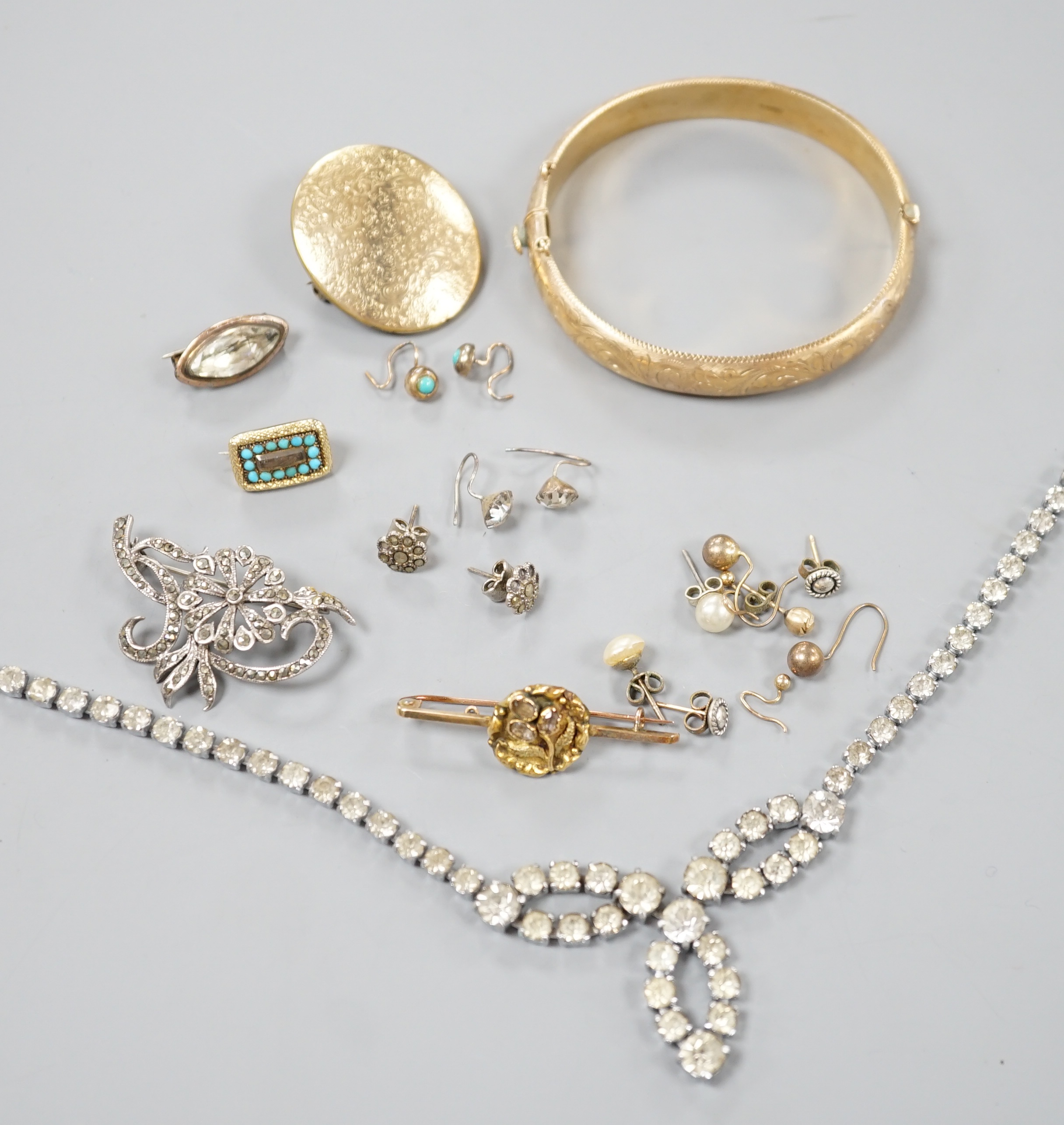 A 9ct gold hinged bangle, 17.4 grams, an engraved yellow metal locket, a 9ct and gem set bar brooch, gross 3.3 grams, a Victorian yellow metal and turquoise set small mourning brooch, one other brooch, assorted earrings